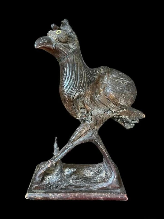 Carved wooden bird sculpture, a very old object showing intricate details, representing stories about our ancestors.