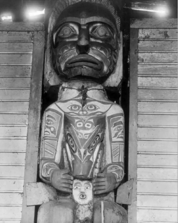 Carved wooden totem pole with intricate painted designs, an old object showing stories of our ancestors.