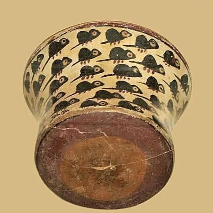 Ancient pottery cup decorated with black mice figures, one of the very old objects that survived from our ancestors.