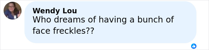 Woman commenting about impulsively getting freckles tattooed on her face, sparking reactions about her appearance.