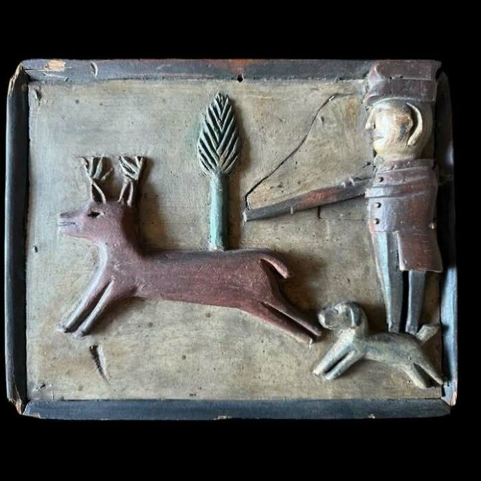 Carved very old object depicting a hunter, dog, and deer, illustrating stories about our ancestors through ancient art.
