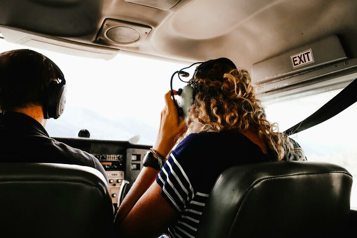 Two pilots in a cockpit wearing headsets, focused on flying during challenging situations handled with calmness.