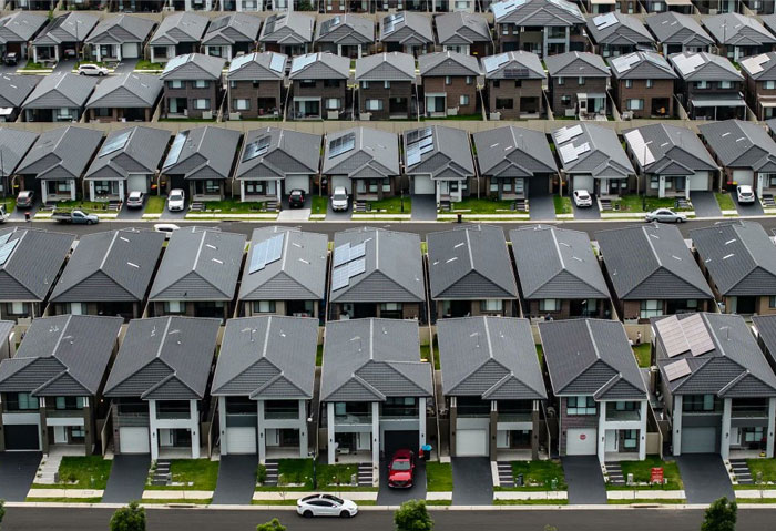 Rows of nearly identical houses showing design and architecture nightmares with poor common sense in suburban neighborhood.