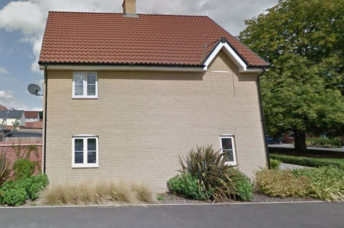 House with mismatched window placement showing design and architecture nightmares that highlight lack of common sense.