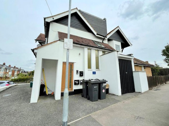 Modern house design with poorly placed trash bins and obstructed garage, showcasing design and architecture nightmares.