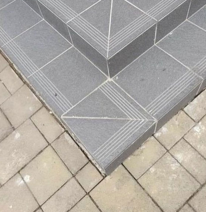 Corner step with mismatched tile design, showcasing design and architecture nightmares that challenge common sense in construction.