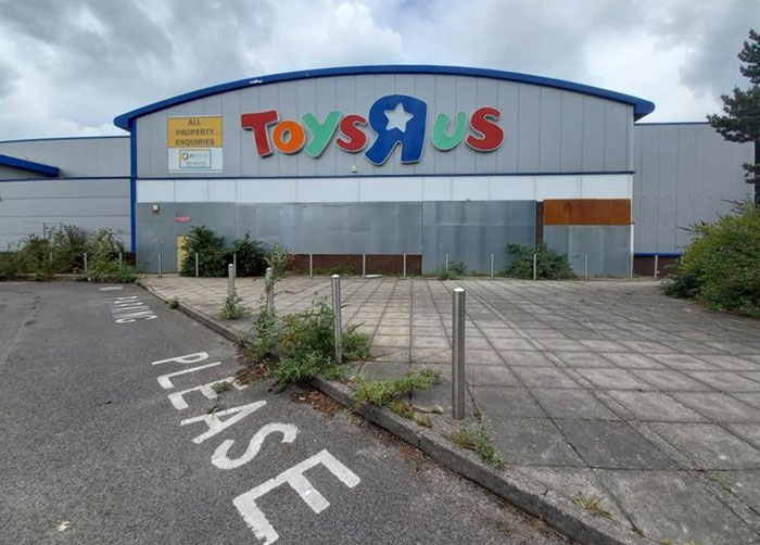 Abandoned Toys R Us store with overgrown plants and poor design, a clear example of design and architecture nightmares.
