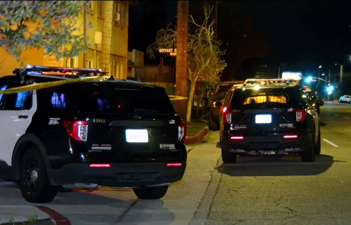 Police SUVs with flashing lights parked on a dimly lit street in LA investigating singer DELAROSA assassination crime scene. Police SUVs with flashing lights parked on a dimly lit street in LA investigating singer DELAROSA assassination crime scene.