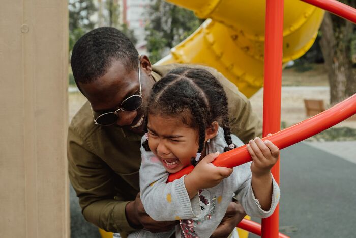 Father and upset child at playground, highlighting common ways parents fail at raising kids and ensure emotional support.