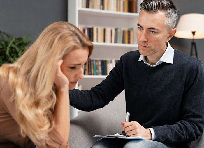 Therapist conducting a hidden test to evaluate a distressed woman during a counseling session in a cozy room.