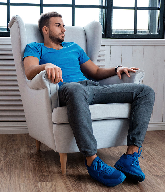 Man sitting in armchair looking thoughtful during a therapy session, illustrating a hidden test therapists may use to judge.