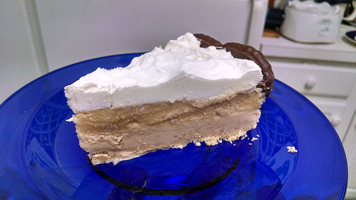 Slice of dessert with whipped topping on a blue plate symbolizing how people's lies got way out of hand in life changes.