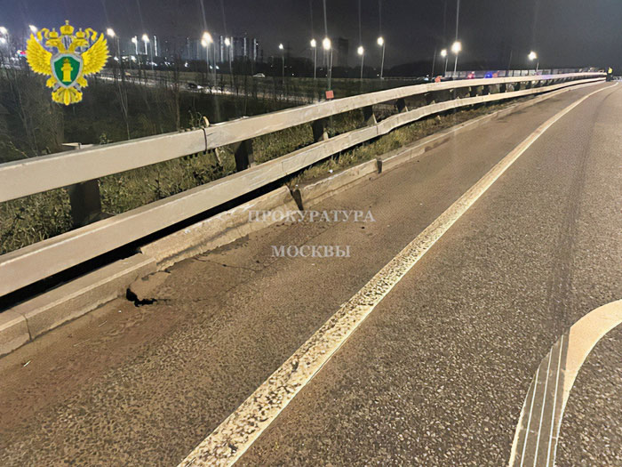 Damaged roadside barrier on a highway at night with dim streetlights, related to crypto scammer case investigation.