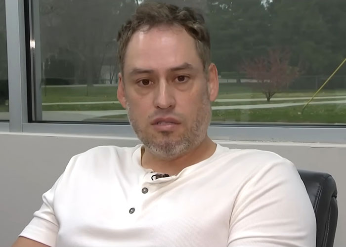 Man speaking in an indoor interview setting revealing Campbell's executive disturbing comments about soup ingredients.