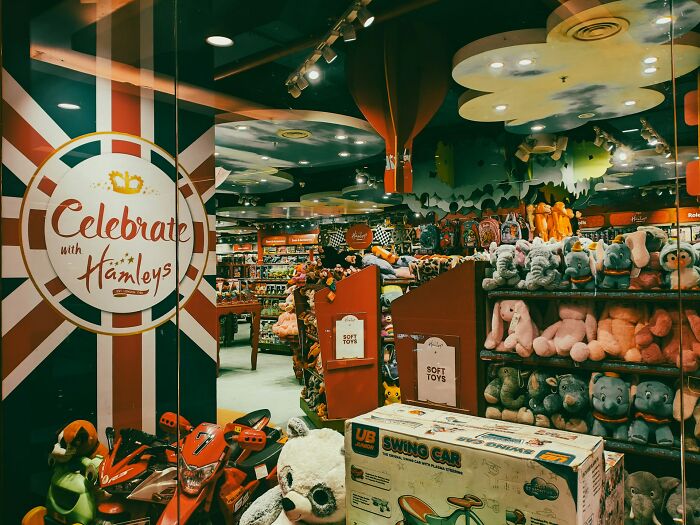 Toy store window display with stuffed animals and toys, illustrating chaos employees see on Black Friday sales events.