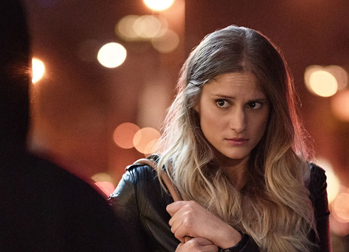 Young woman looking suspicious and uneasy during a nighttime conversation, reflecting fiance detective concerns about a suspicious partner.