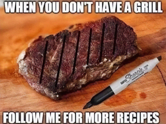 Steak with grill marks drawn using a black marker on a wooden board, illustrating stupid food memes for stupid people.