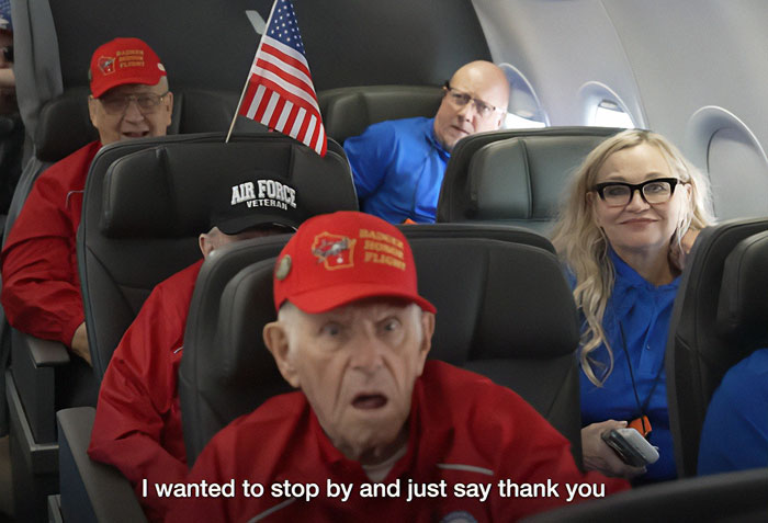 War veterans wearing caps and emotional expressions seated on a plane, representing Barack Obama surprise moment.