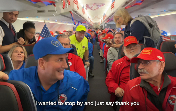 War veterans on a decorated plane reacting emotionally to a surprise visit during an event honoring their service.