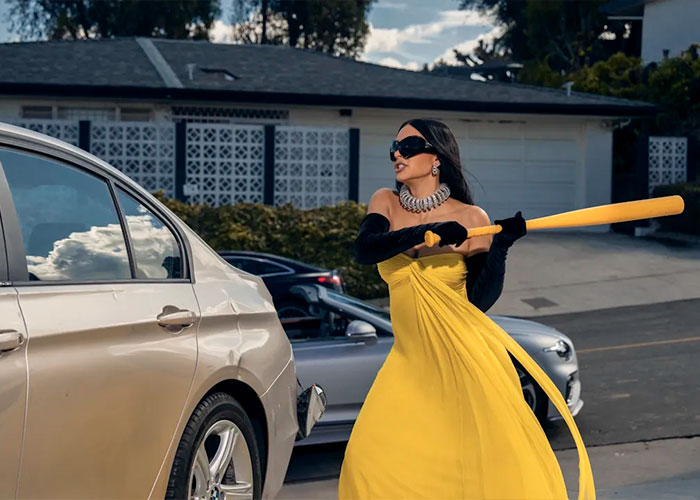 Woman in a yellow dress holding a baseball bat near a damaged car, depicting the worst scenes from All's Fair so far. Woman in a yellow dress holding a baseball bat near a damaged car, depicting the worst scenes from All's Fair so far.