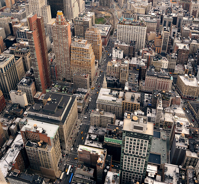 Aerial view of a dense cityscape illustrating urban safety concerns like metal detectors at school.