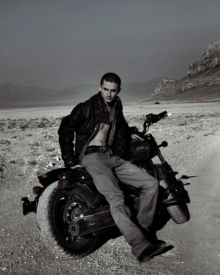 Timothée Chalamet in a leather jacket sitting on a motorcycle in a desert landscape, enjoying a guys night out. Timothée Chalamet in a leather jacket sitting on a motorcycle in a desert landscape, enjoying a guys night out.