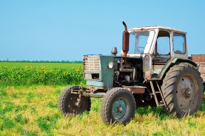 Old inherited tractor parked in a field, symbolizing a toxic MIL dispute and son-in-law's petty response.