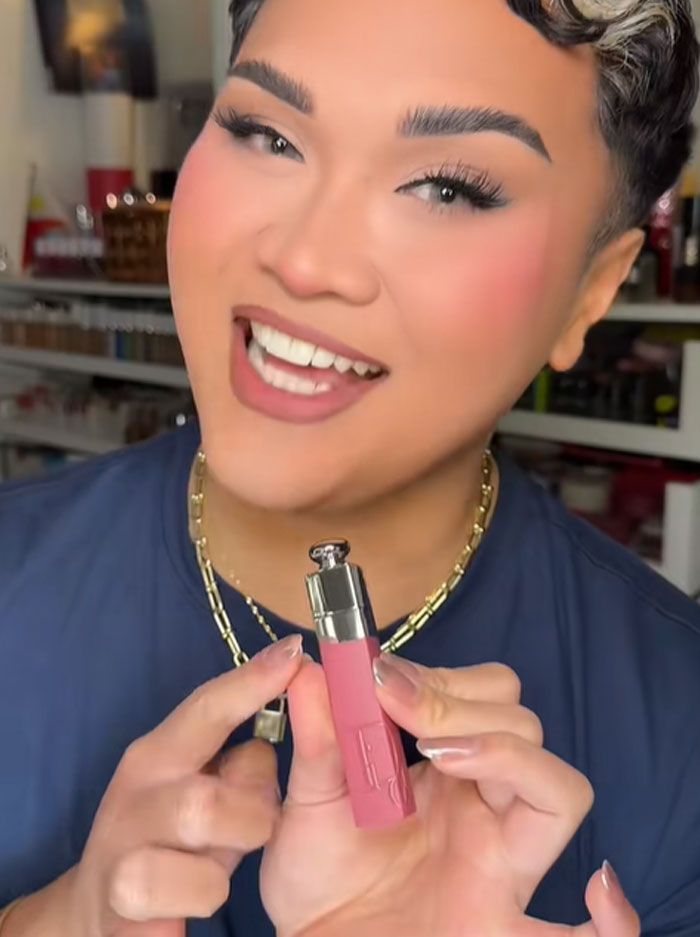 Person holding a Dior lip product, discussing the luxury advent calendar and people's reactions to its price.