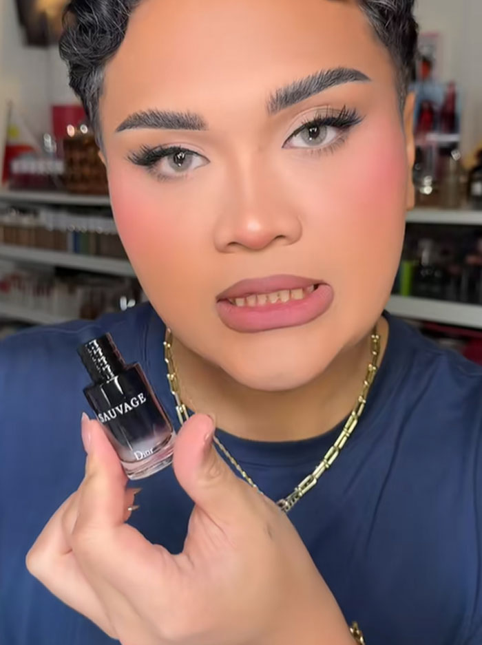 Person holding a Dior Sauvage perfume bottle, reacting to the luxury advent calendar priced at 1,000 dollars.