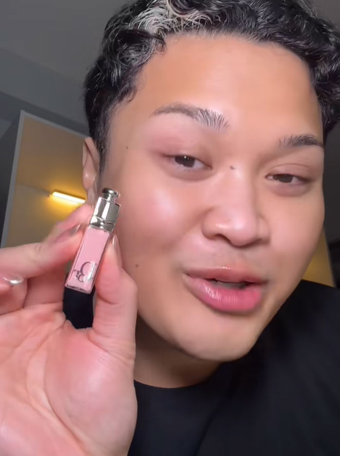 Person holding a small Dior lip gloss, reacting to the luxury advent calendar and sharing thoughts on its $1,000 price.
