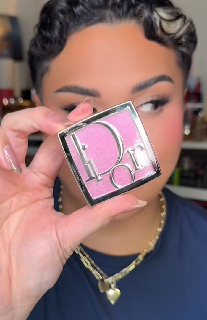 Person holding a pink Dior makeup compact, highlighting Dior advent calendar luxury beauty product.
