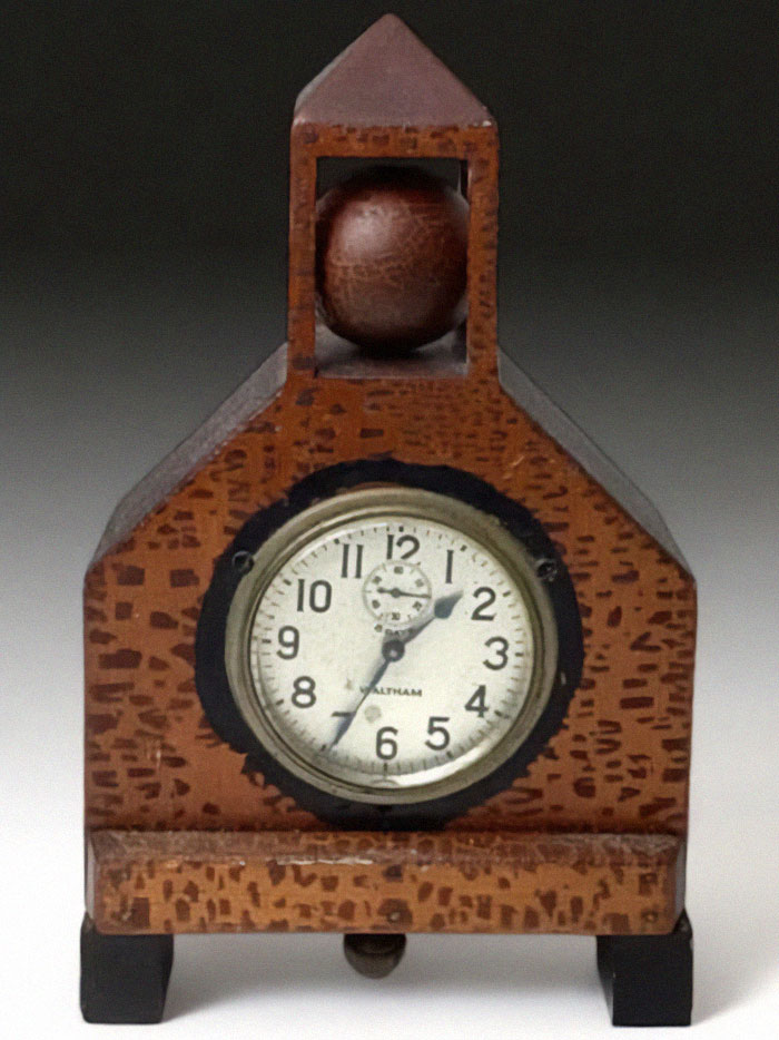 Very old wooden clock with a round face and vintage design, an object that survived from our ancestors' time.