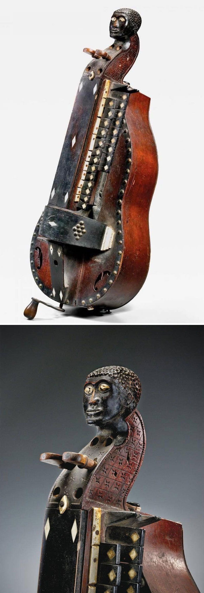Very old musical instrument with carved human figure, showing intricate details and signs of ancient craftsmanship.