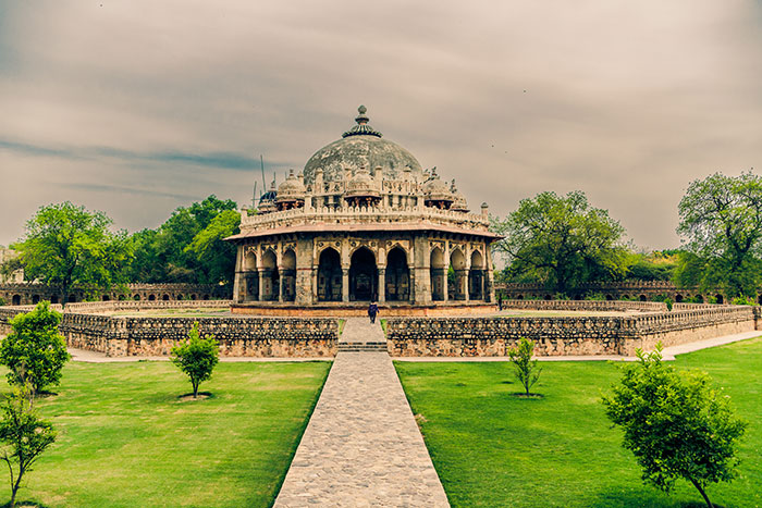 Historic stone monument surrounded by greenery, illustrating places solo female travelers do not recommend for safety.