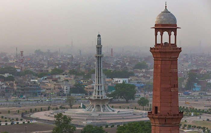 View of Lahore city with Minar-e-Pakistan and a historic tower, highlighting unsafe places for solo female travelers.