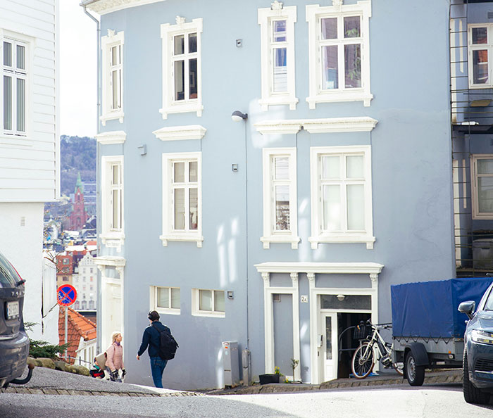 Two solo female travelers walking on a quiet street near residential buildings, highlighting solo female traveler safety concerns.