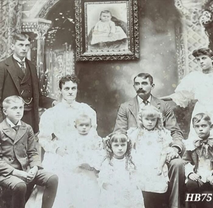 Victorian Edwardian pictures showing a formal family portrait with adults and children dressed in period clothing.