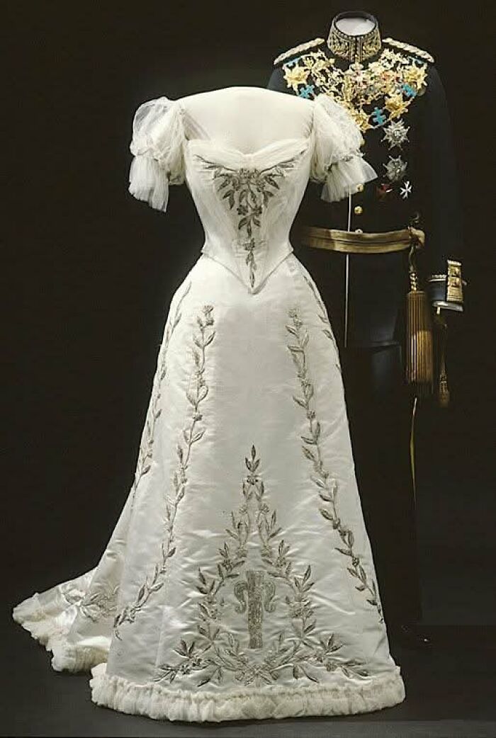 Victorian-Edwardian pictures of an elegant white embroidered gown with puffed sleeves and a decorated military uniform.