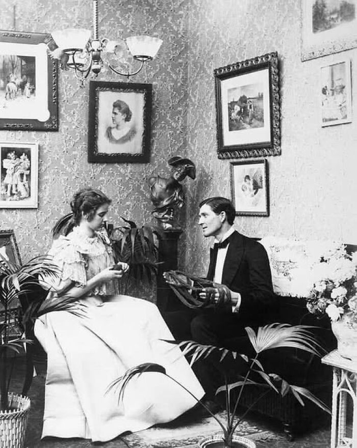 Victorian-Edwardian pictures showing a woman in a white dress and a man in formal wear sitting in an ornate room.
