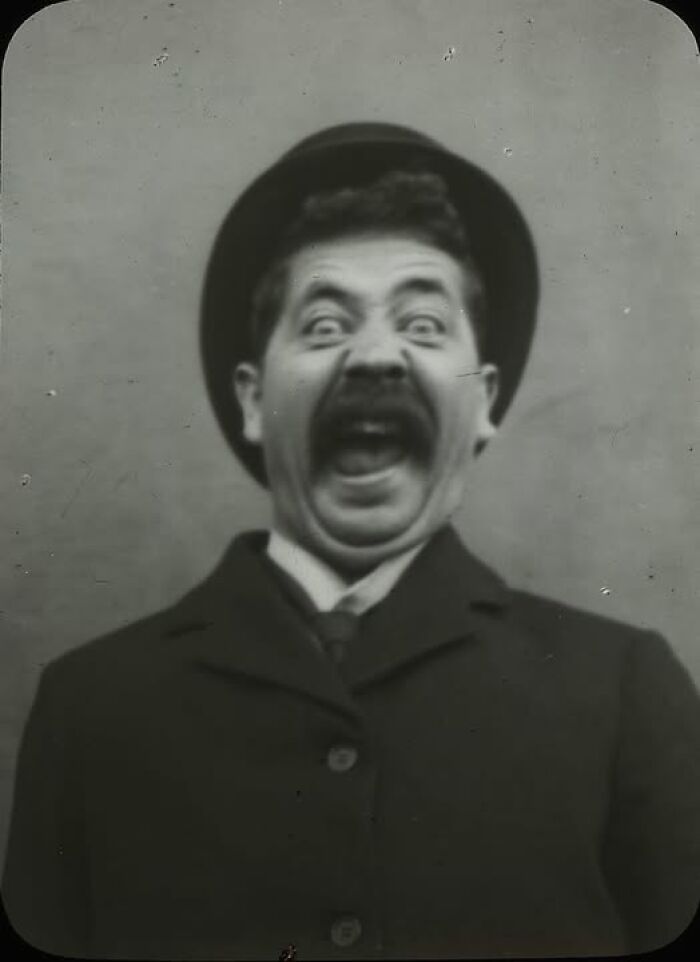 Victorian-Edwardian pictures of a man wearing a hat and coat making a surprised and humorous facial expression in black and white.
