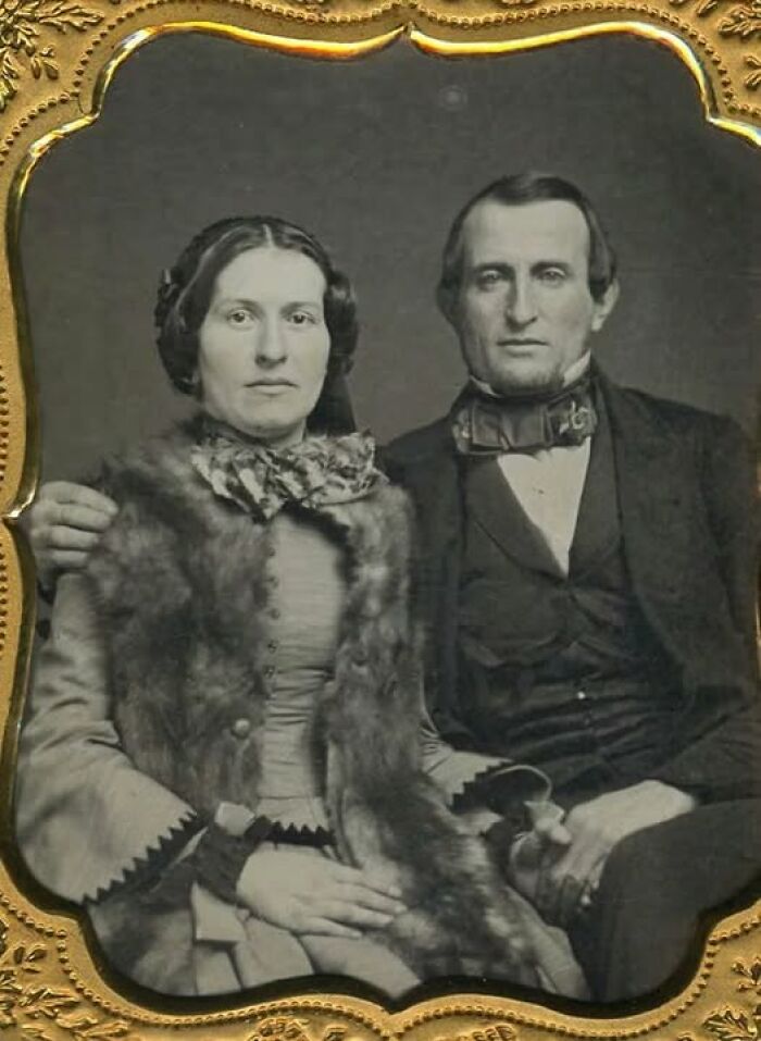 Victorian-Edwardian pictures of a formally dressed couple seated indoors, framed with a decorative gold border.