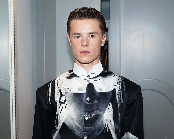 Young actor portraying iconic Hunger Games character in promotional event for the new film adaptation.