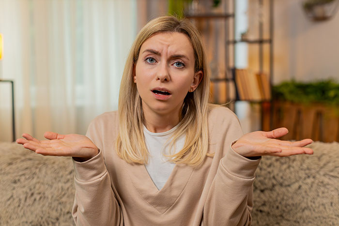 Woman looking confused and frustrated at home, representing an avid walker dealing with criticism from family.