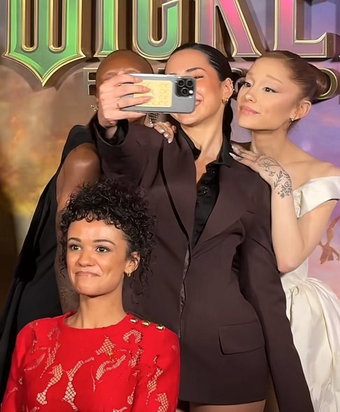 Wicked cast taking a selfie at event, sparking debate on disability inclusion after Marissa Bode was excluded from the photo.