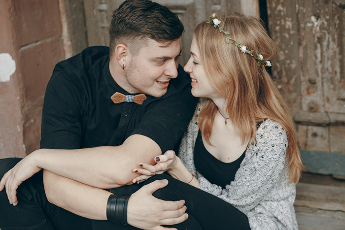 Young man happy and smiling while sitting close to woman, symbolizing man happy ex wife caught cheating emotion.