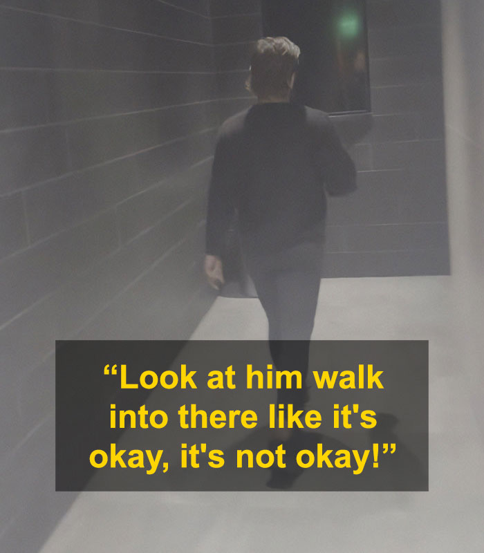 Person walking down dimly lit hallway with text about confrontation involving alleged trans woman in ladies room controversy.