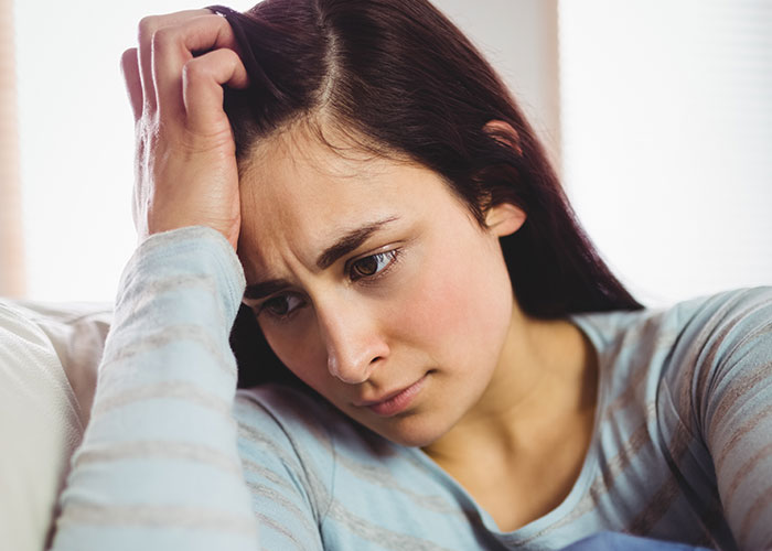 Woman looking stressed and frustrated, expressing she doesn&rsquo;t want to cook a foreign traditional Christmas spread.