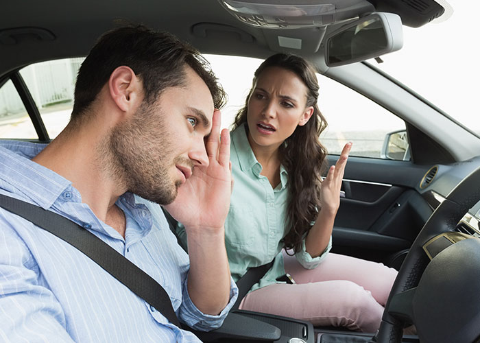 Frustrated woman expressing she doesn&rsquo;t want to cook foreign traditional Christmas spread while sitting in car with man.