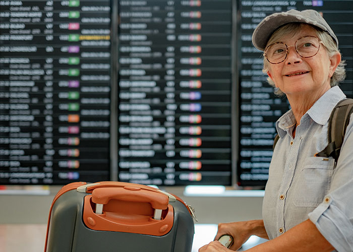 Elderly woman with glasses and cap waiting at airport, appearing overwhelmed while babysitting multiple kids. Elderly woman with glasses and cap waiting at airport, appearing overwhelmed while babysitting multiple kids.