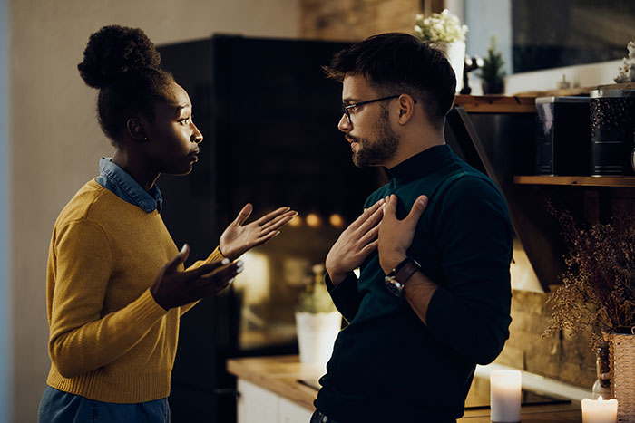 A tense conversation between a woman and man inside a home about hosting a blended family Christmas gathering.
